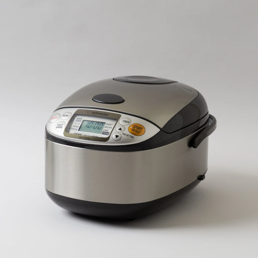 Rice cooker with digital display on a light gray background