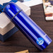 Blue thermos bottle on a wooden surface with a visible brand logo.