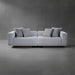 Gray sofa with cushions on a gray floor and wall