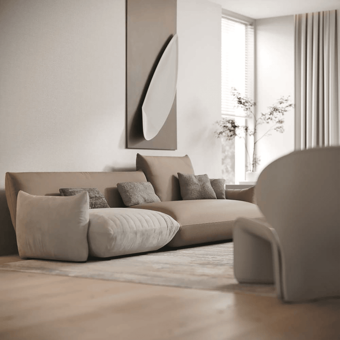 Modern living room with a beige sofa and decorative pillows.