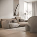 Modern living room with a beige sofa and decorative pillows.