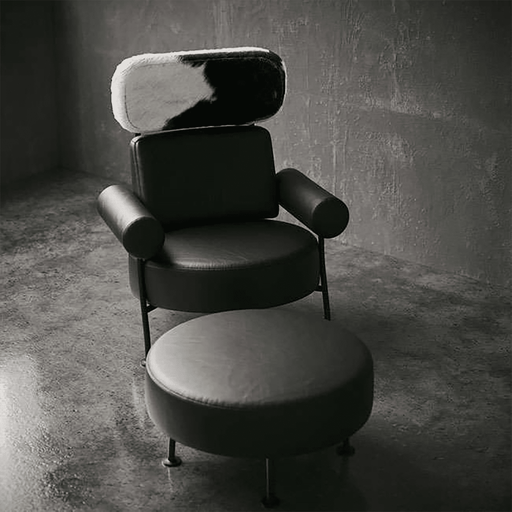 Modern black chair with cowhide pattern backrest in a dimly lit room.