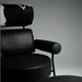 Black leather armchair with cowhide backrest on a gray background