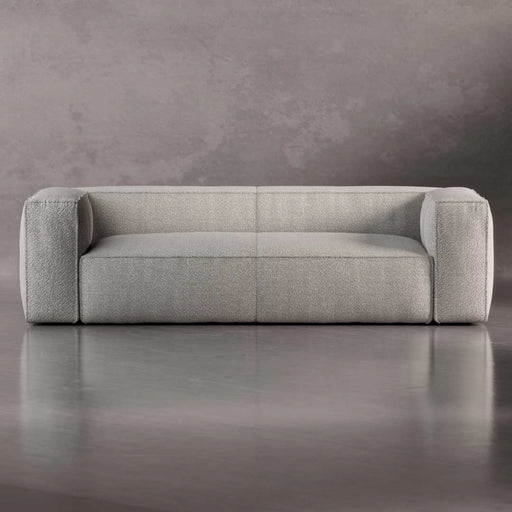 Gray sofa on a reflective surface with a neutral background