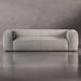 Gray sofa on a reflective surface with a neutral background