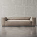 Beige sofa against a gray concrete wall
