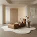 Modern living room with brown leather sofa, ottoman, and side table on a white rug.
