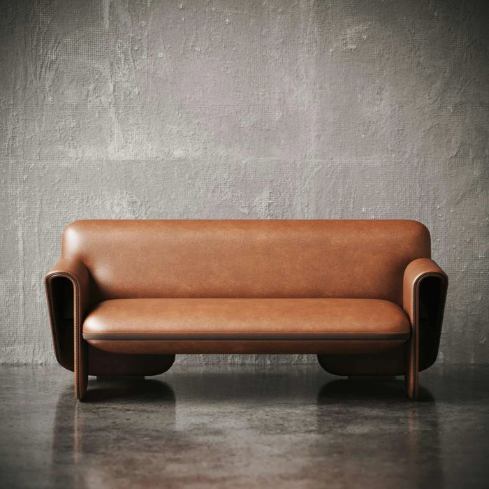 Brown leather sofa against a textured gray wall.