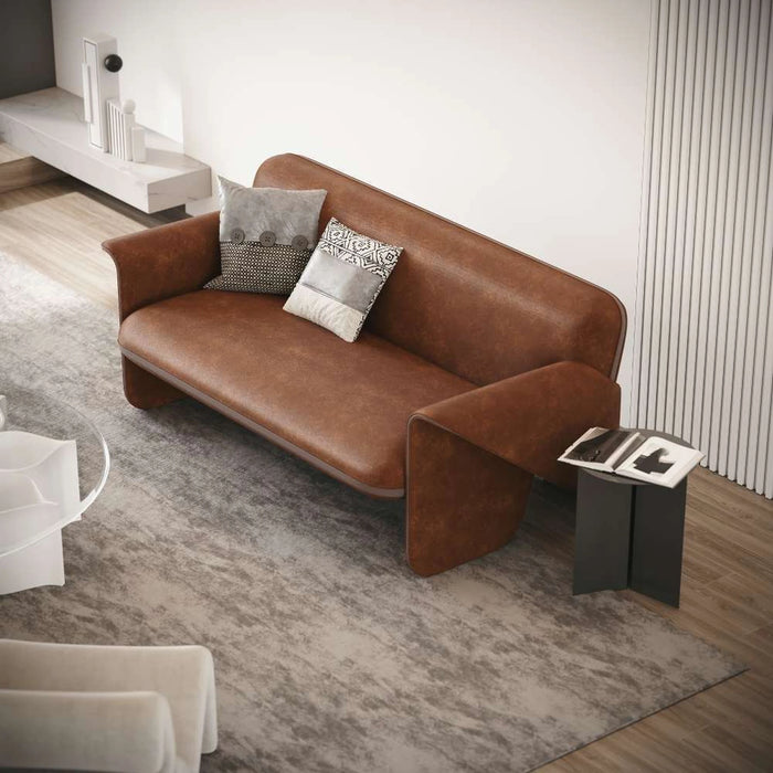 Brown leather sofa with patterned cushions in a modern living room.