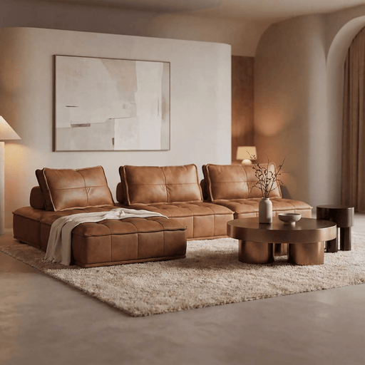 Modern living room with a brown leather sectional sofa, coffee table, and abstract art on the wall.