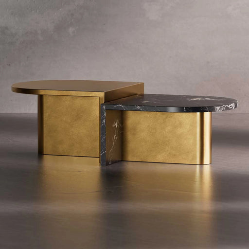 Modern coffee table with gold base and black marble top on a gray background