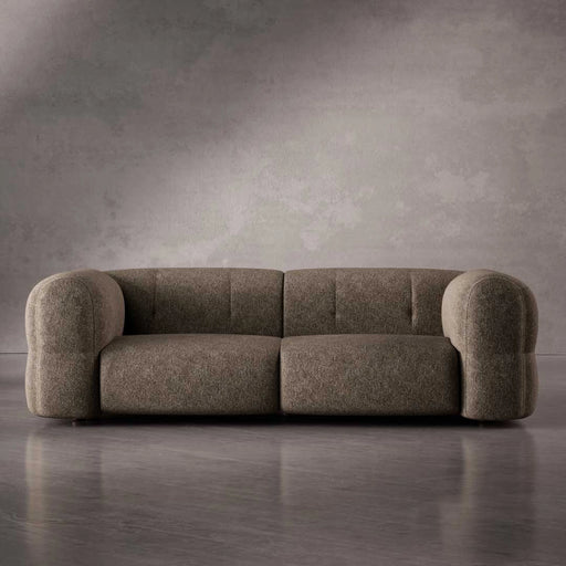 Brown sofa against a gray wall