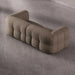 Brown tufted sofa on a gray concrete floor