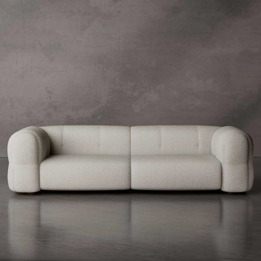Beige sofa against a gray wall