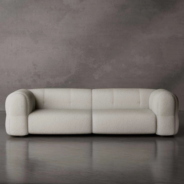 Beige sofa against a gray wall