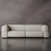 Beige sofa against a gray wall
