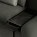 Dark gray sofa with a marble-patterned tray on a dark background