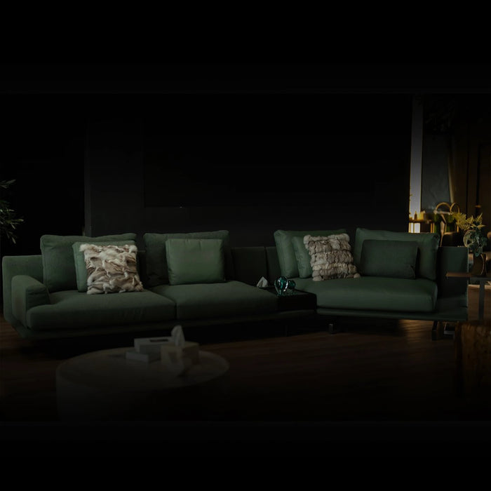 Dark living room with a green sofa and decorative items.
