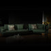 Dark living room with a green sofa and decorative items.