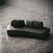 Modern black leather sofa on a concrete floor