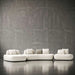 Modern white sofa against a textured gray wall