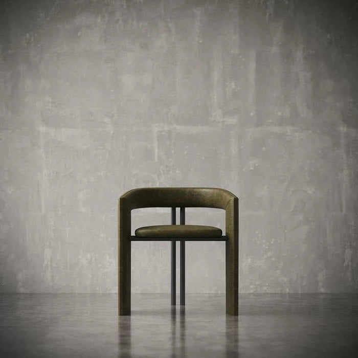 Modern chair with a metallic finish against a textured gray wall.