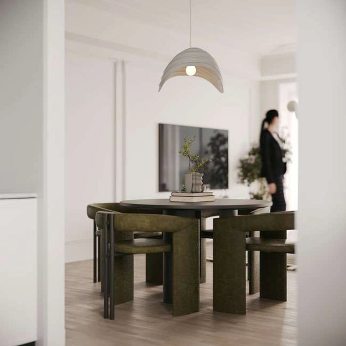 Dining room with a modern table and chairs, featuring a pendant light and decor elements.