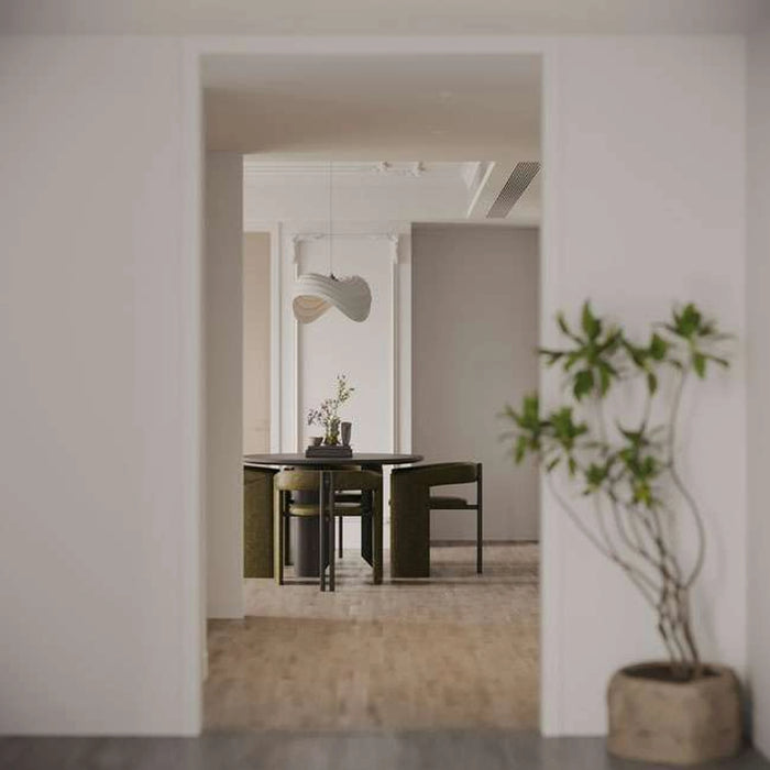 Modern interior with a dining area and a plant in a pot.