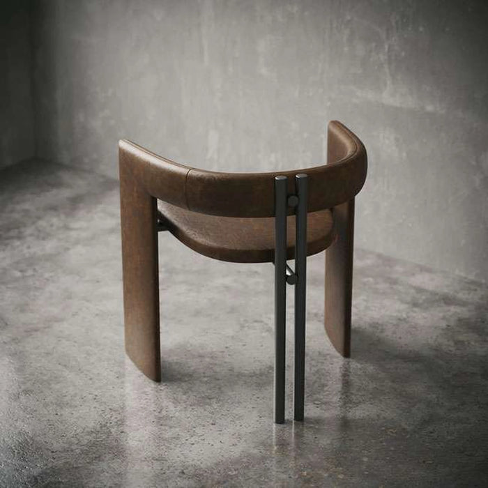 Brown leather stool with black metal legs on a gray concrete floor.