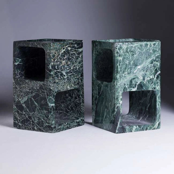 Two green marble stools with a gray background