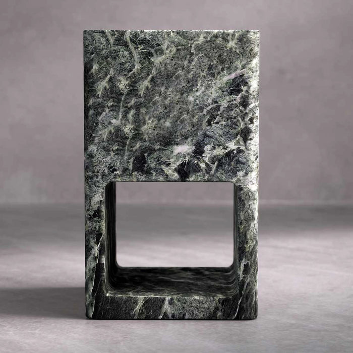 Marble cube with a rectangular cutout on a gray background