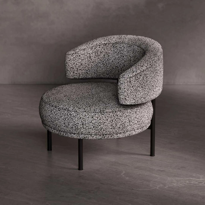 Modern armchair with textured gray upholstery on a dark floor and gray wall background