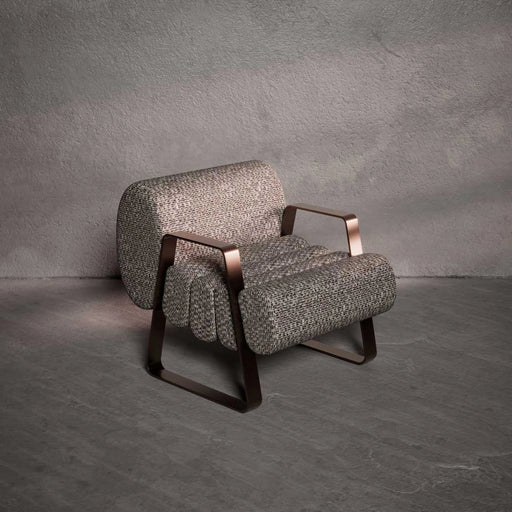 Gray textured armchair with bronze accents on a gray background