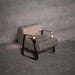 Gray textured armchair with bronze accents on a gray background