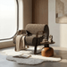 Cozy living room with a textured armchair, wooden side table, and a cup of coffee.