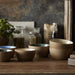 Set of ceramic bowls on a wooden surface with a rustic background