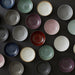 Collection of colorful ceramic plates arranged on a dark surface