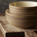 Stack of brown ceramic bowls on a wooden surface