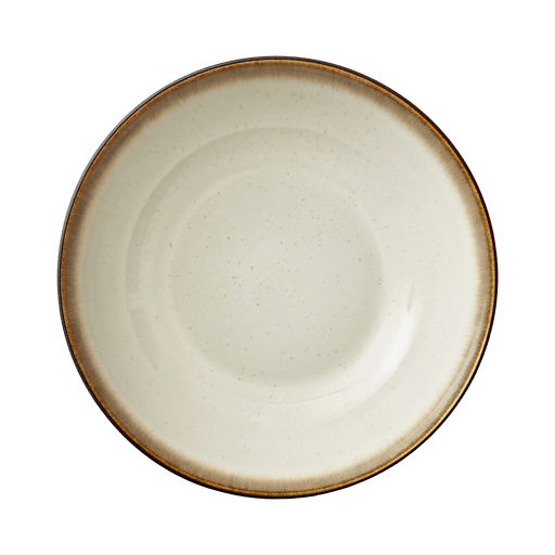 Round ceramic plate with a brown rim on a green background