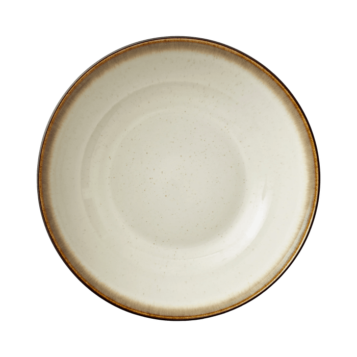 Round ceramic plate with a brown rim on a green background