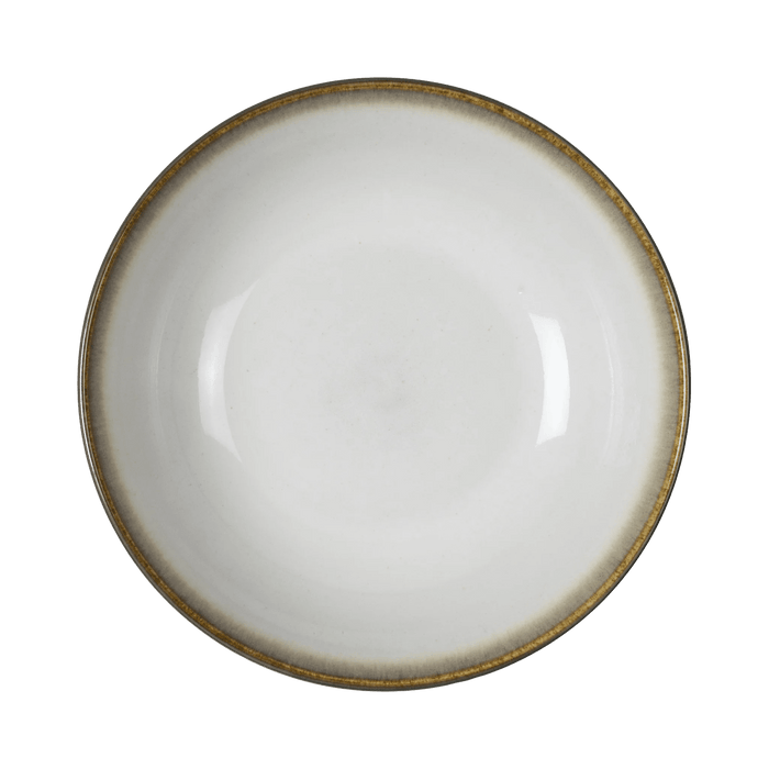 White ceramic bowl with a gold rim on a green background