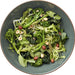 Green salad with broccoli and nuts in a blue bowl