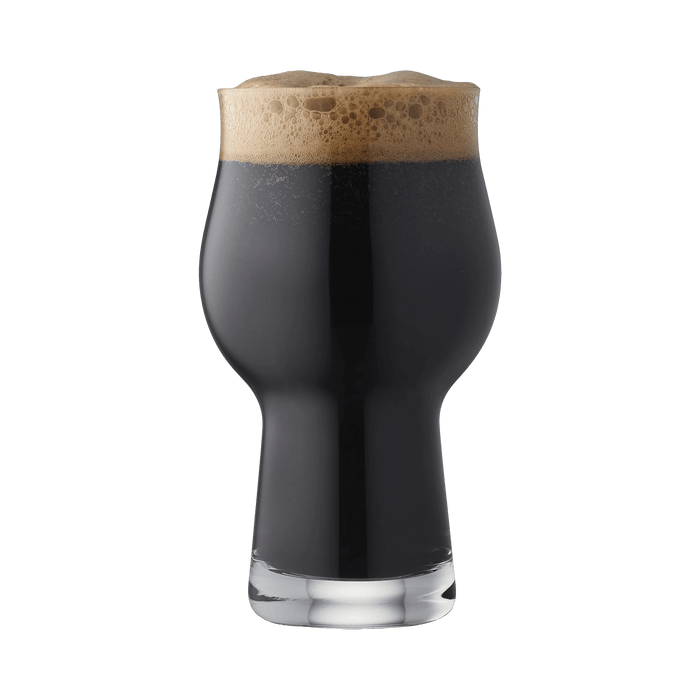 Glass of dark beer with a foamy head on a white background