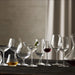 Collection of various glassware on a dark surface with a neutral background