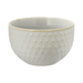 White ceramic bowl with textured design on a green background