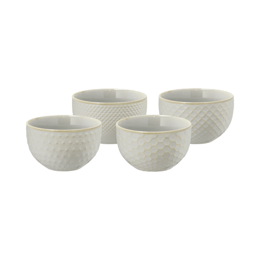 Set of four white textured bowls on a green background