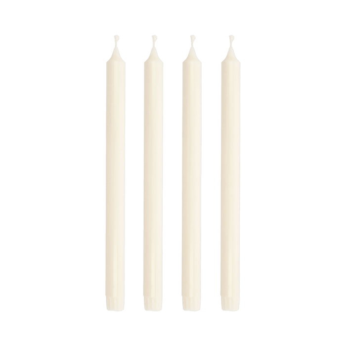 Four white candles on a green background