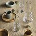 Table setting with cups, mugs, and glassware on a wooden surface
