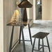 Modern black table with a stool in a stylish interior setting
