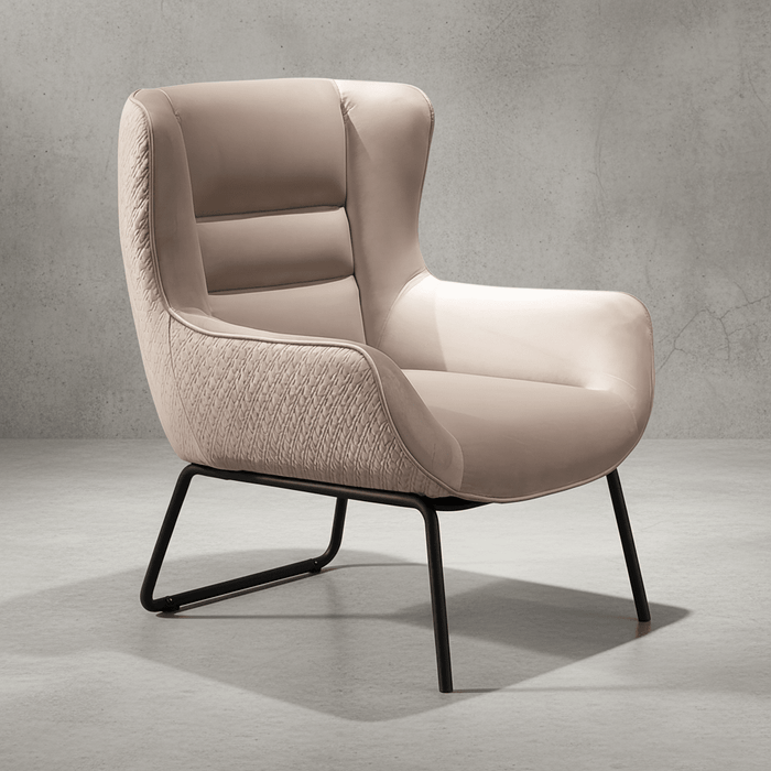 Beige armchair with black metal legs on a gray concrete background